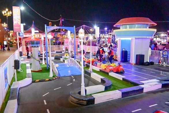 Rescue Mission ride-on track at night at Global Village